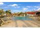 Resort-style pool area with lounge chairs, palm trees, and clear blue water, perfect for relaxation and recreation at 43406 Boardwalk Loop, Punta Gorda, FL 33982