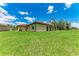 Expansive backyard featuring lush green grass, perfect for outdoor activities and relaxation on a bright, sunny day at 4380 Maddock Cir, North Port, FL 34286
