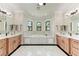 Elegant bathroom with marble floors, double vanity, soaking tub, and large windows at 4380 Maddock Cir, North Port, FL 34286