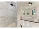 Luxury bathroom featuring a marble shower and soaking tub at 4380 Maddock Cir, North Port, FL 34286