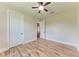 Bedroom with wood floors and doors leading to other rooms at 4380 Maddock Cir, North Port, FL 34286