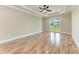 Bedroom with wood flooring, ceiling fan, french doors, and view of yard at 4380 Maddock Cir, North Port, FL 34286