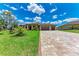 Beautifully landscaped home with a spacious driveway made of decorative pavers at 4380 Maddock Cir, North Port, FL 34286