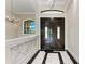 The home welcomes you with an elegant chandelier and decorative marble accents at 4380 Maddock Cir, North Port, FL 34286