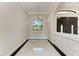 Elegant foyer with tile flooring, chandelier and a view of the front door at 4380 Maddock Cir, North Port, FL 34286