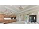 A luxurious kitchen features granite countertops, wood cabinets, and chandeliers at 4380 Maddock Cir, North Port, FL 34286