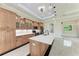 Spacious kitchen with an island, wooden cabinets, recessed lighting and stainless steel appliances at 4380 Maddock Cir, North Port, FL 34286