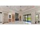 A stylish living room with a sleek fireplace, marble floors, and modern lighting at 4380 Maddock Cir, North Port, FL 34286