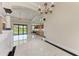 Open living room with luxury flooring, pillars, and view into kitchen at 4380 Maddock Cir, North Port, FL 34286