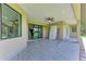 Covered patio with ceiling fan and sliding glass doors at 4380 Maddock Cir, North Port, FL 34286