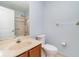 Compact bathroom with single vanity, toilet, and shower/tub combination with sliding glass doors at 541 Wekiva River Ct # 94, Englewood, FL 34223