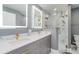 Modern bathroom featuring dual sinks, granite countertops, and a glass shower with gold fixtures at 541 Wekiva River Ct # 94, Englewood, FL 34223