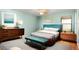 Stylishly furnished bedroom featuring wood floors, a ceiling fan, and a large window for natural light at 541 Wekiva River Ct # 94, Englewood, FL 34223