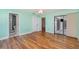 Bright bedroom with wood floors, double closets, and a sliding glass door to an enclosed patio at 541 Wekiva River Ct # 94, Englewood, FL 34223