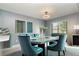 Elegant dining room with stylish furnishings, modern lighting, and large windows at 541 Wekiva River Ct # 94, Englewood, FL 34223