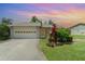 Charming single-story home with a well-manicured lawn, screened entrance, and two-car garage at 541 Wekiva River Ct # 94, Englewood, FL 34223