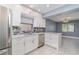 Modern kitchen featuring stainless appliances, white cabinetry, breakfast bar and natural light at 541 Wekiva River Ct # 94, Englewood, FL 34223