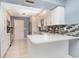 Modern kitchen with white cabinets, stainless steel appliances, and stylish backsplash at 541 Wekiva River Ct # 94, Englewood, FL 34223