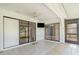The covered outdoor living space includes a ceiling fan, tile flooring, and sliding glass doors at 541 Wekiva River Ct # 94, Englewood, FL 34223