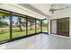 The enclosed lanai features tile floors, large window views, and a ceiling fan at 541 Wekiva River Ct # 94, Englewood, FL 34223
