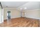 Large open living room with hardwood flooring, neutral walls, and bright overhead lighting at 541 Wekiva River Ct # 94, Englewood, FL 34223