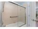 Bathroom with a shower/tub with glass sliding door and safety bars at 541 Wekiva River Ct # 94, Englewood, FL 34223
