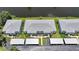 Aerial view of condo buildings with lush green surroundings near canal at 5725 Greenwood Ave # 2101, North Port, FL 34287