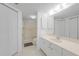Bright bathroom features a large mirror, walk-in shower, and tile flooring at 5725 Greenwood Ave # 2101, North Port, FL 34287