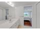 Bright bathroom featuring double sinks and a pass-through to the bedroom at 5725 Greenwood Ave # 2101, North Port, FL 34287