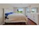 Bedroom featuring a queen size bed with a large window and dresser at 5725 Greenwood Ave # 2101, North Port, FL 34287