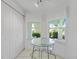 Cozy breakfast nook with glass table and natural light from two windows at 5725 Greenwood Ave # 2101, North Port, FL 34287