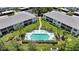 Aerial view of community pool with lounge chairs and tropical landscaping at 5725 Greenwood Ave # 2101, North Port, FL 34287
