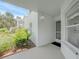 Inviting entryway with white walls, exterior lighting, and lush landscaping at 5725 Greenwood Ave # 2101, North Port, FL 34287