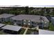 Waterfront condo building featuring covered parking, manicured landscaping, and balconies at dusk at 5725 Greenwood Ave # 2101, North Port, FL 34287
