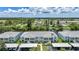 Waterfront condo building featuring covered parking, manicured landscaping, and balconies at 5725 Greenwood Ave # 2101, North Port, FL 34287