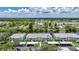 Waterfront condo building featuring covered parking, manicured landscaping, and balconies at 5725 Greenwood Ave # 2101, North Port, FL 34287