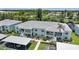 Waterfront condo building featuring covered parking, manicured landscaping, and balconies at 5725 Greenwood Ave # 2101, North Port, FL 34287