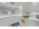 Bright kitchen featuring white cabinets, stainless steel appliances and a breakfast bar at 5725 Greenwood Ave # 2101, North Port, FL 34287