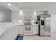Well-lit kitchen with modern appliances, white cabinets, and neutral tile floors at 5725 Greenwood Ave # 2101, North Port, FL 34287