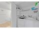 Laundry room with shelving above a white washer and dryer next to a toilet at 5725 Greenwood Ave # 2101, North Port, FL 34287