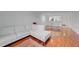 Cozy living room featuring a white sectional sofa and shiny hardwood floors at 5725 Greenwood Ave # 2101, North Port, FL 34287