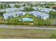 An aerial view showcases the neighborhood, the pool and manicured landscaping at 5725 Greenwood Ave # 8203, North Port, FL 34287