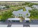 Aerial view of the community, showcasing ample parking, tropical landscaping and nearby waterways at 5725 Greenwood Ave # 8203, North Port, FL 34287