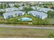 An aerial view showcases the neighborhood, the pool and manicured landscaping at 5725 Greenwood Ave # 8203, North Port, FL 34287