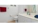 Clean bathroom featuring a white vanity with a sink and a toilet with tiled floors at 5725 Greenwood Ave # 8203, North Port, FL 34287