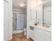 Well-lit bathroom features a glass-enclosed shower and a white vanity with ample counter space at 5725 Greenwood Ave # 8203, North Port, FL 34287
