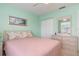 Comfortable bedroom with pastel green walls, includes closet, dresser, and calming decor at 5725 Greenwood Ave # 8203, North Port, FL 34287