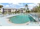 A sparkling community pool with sun loungers and tables offers relaxation in a gated environment at 5725 Greenwood Ave # 8203, North Port, FL 34287