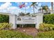 Coco Plum Condominium entrance with well-maintained landscaping and a clear community sign at 5725 Greenwood Ave # 8203, North Port, FL 34287