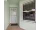 Close-up of the front door and window, offering a glimpse of the interior and natural light at 5725 Greenwood Ave # 8203, North Port, FL 34287